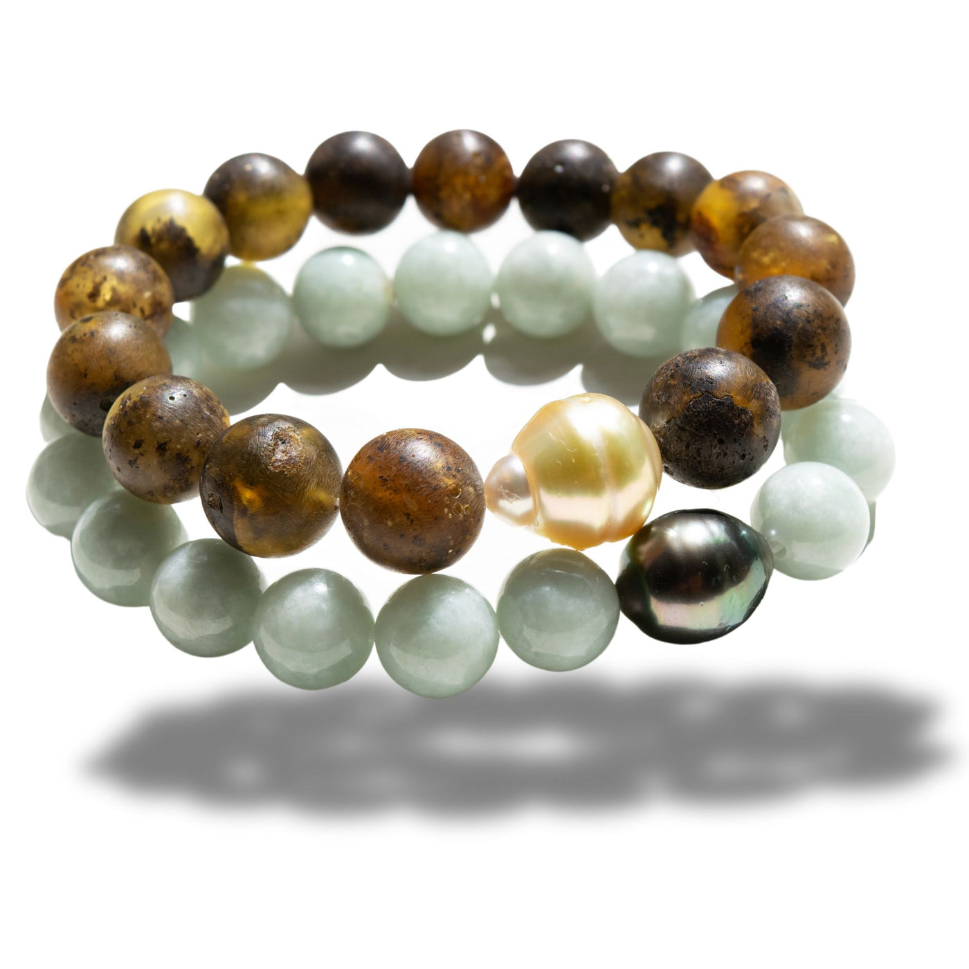 Discover the elegance of our Golden South Sea Pearl Men’s Bracelet, featuring 18K yellow gold and a unique mix of gemstones, including amber, tanzanite, lapis lazuli, green jade, Edo wood, and more. This sophisticated design blends luxury and natural elements, creating a bold statement piece for the modern man. Perfect for collectors and those who appreciate refined craftsmanship.