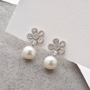 Dazzling Diamond Flower Earrings, boasting gleaming White South Sea Pearls and set in white gold.