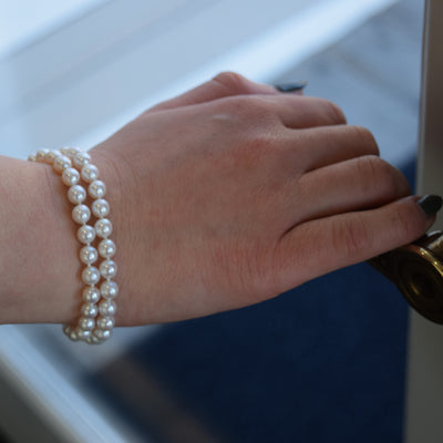Dual Strand Freshwater Bracelet. Featuring lustrous white pearls and a gold clasp