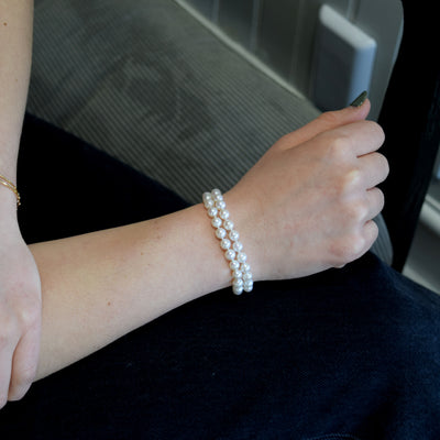 Dual Strand Freshwater Bracelet. Featuring lustrous white pearls and a gold clasp