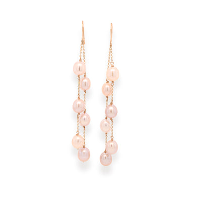 These playful pearl cascades showcase stunning light pink pearls in luxurious yellow gold settings.