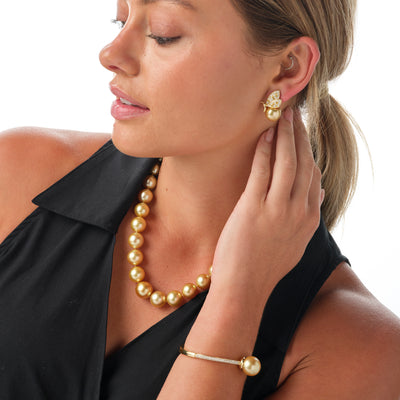 Available in elegant Golden or White South Sea Pearl Bracelet. Crafted in yellow gold, this hinge-style bracelet is accentuated with sparkling diamonds.