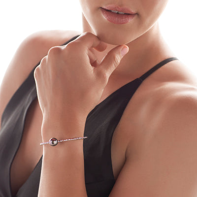 Model wearing 18K Gold Bangle with Black Pearl