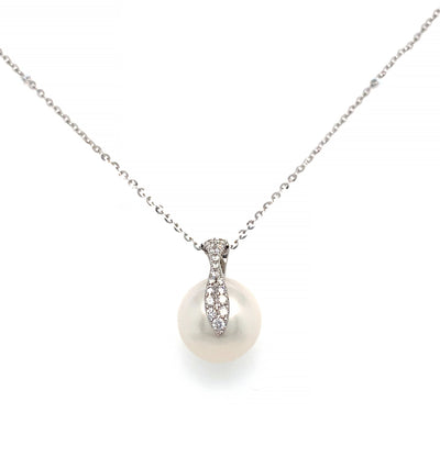 This elegant pendant showcases a 12mm White South Sea Pearl complemented by diamond accents, all set on an 18KW gold chain and mounting.
